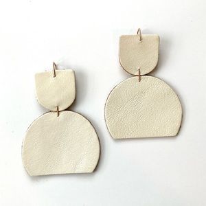Dear survivor white leather statement earrings.